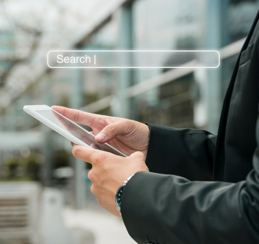 Someone typing a search for google on their tablet
