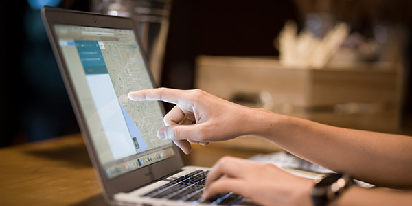 Woman looking at google maps on her computer