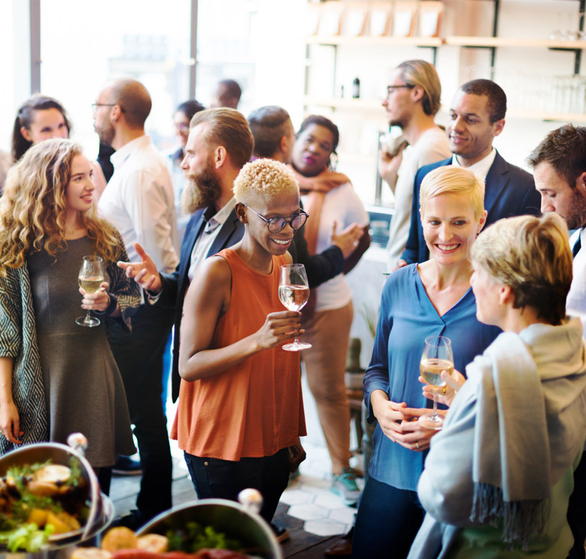A group of people drinking wine and talking at a restaruant