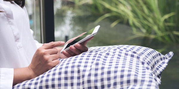 A picture of a man looking at his phone outside