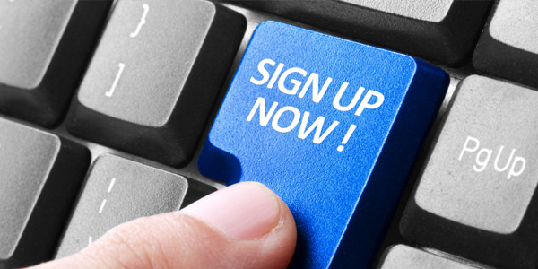 Someone clicking a button that says sign up now!