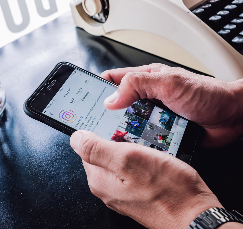 Man looking at instagram profile on his phone