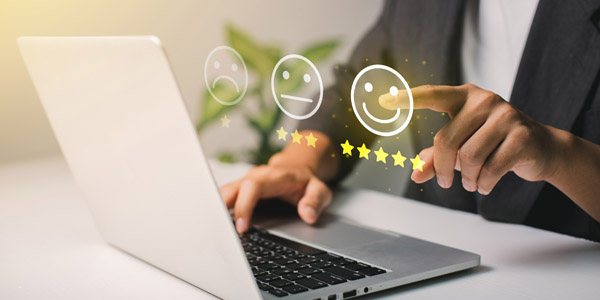 A man leaving a business a review on his computer