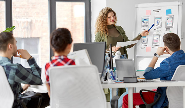Woman presententing to her team in office
