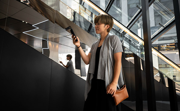 A woman in a shopping center looking at her phone