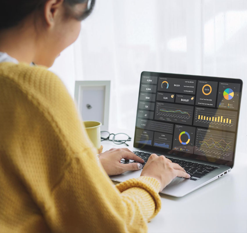 A woman on her computer looking at marketing metrics