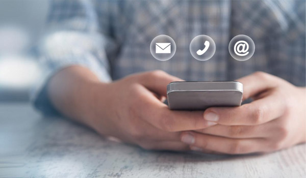 A person holding their phone with social icons above the phone